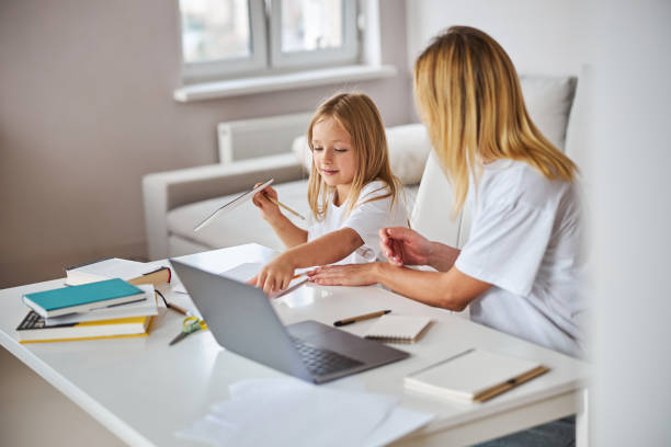 istock Image of workflow attractive charming female and small miss at the white table in room inside 1284291302