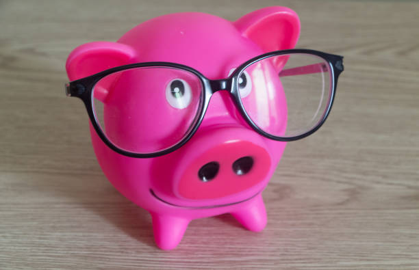 istock Piggy bank and glasses 1284291484