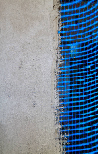 istock wall with applied plaster and blue reinforcing grid sticking out from under it 1284291492