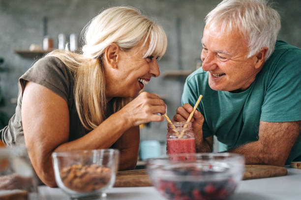 istock Loving couple drinking smoothie in kitchen 1284294550