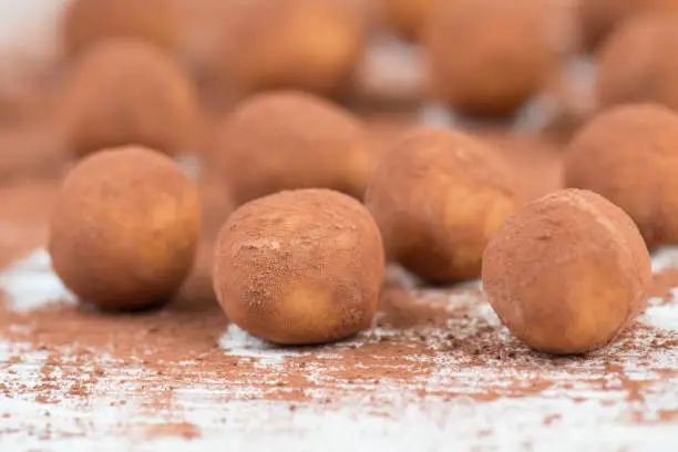 Photo of Marzipan potatoes, in german called Marzipankartoffeln, with cacao powder, sweets for christmas, empty copy space