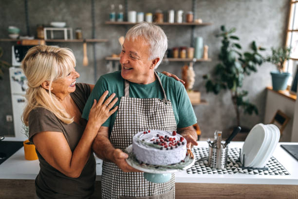 istock Couple holding fresh homemade cake in kitchen 1284294849