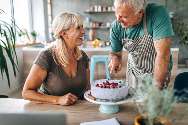 istock Man surprising wife with birthday cake 1284295588