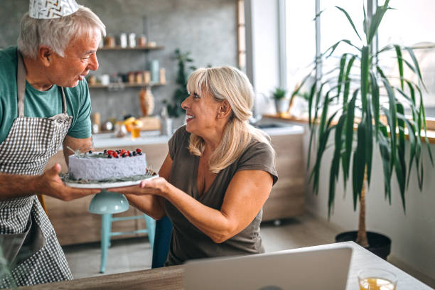 istock Man surprising wife with birthday cake 1284295595