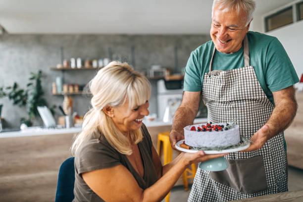 istock Man surprising wife with birthday cake 1284295672