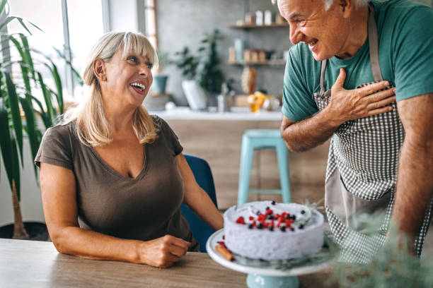 istock Man surprising wife with birthday cake 1284295682