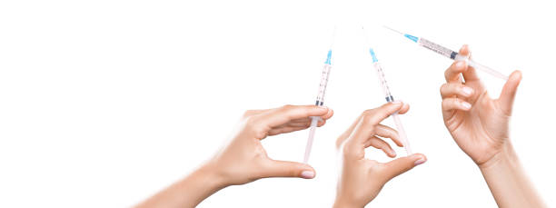istock Hand holding syringe with vaccine against corona virus. 1284295717