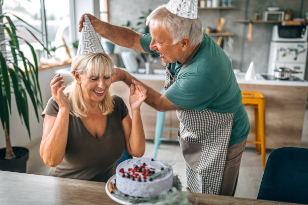istock Man surprising wife with birthday cake 1284295718