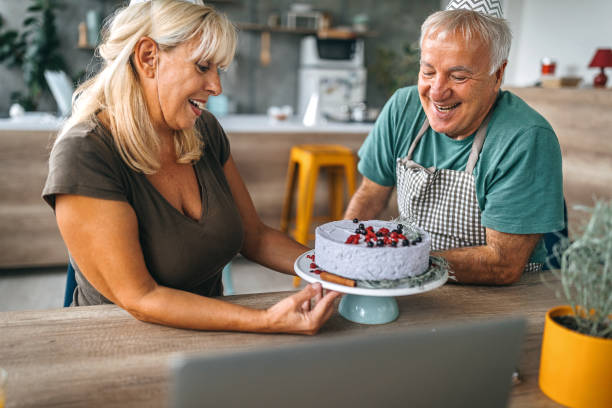 istock Man surprising wife with birthday cake 1284295730