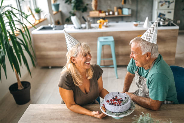 istock Man surprising wife with birthday cake 1284295747