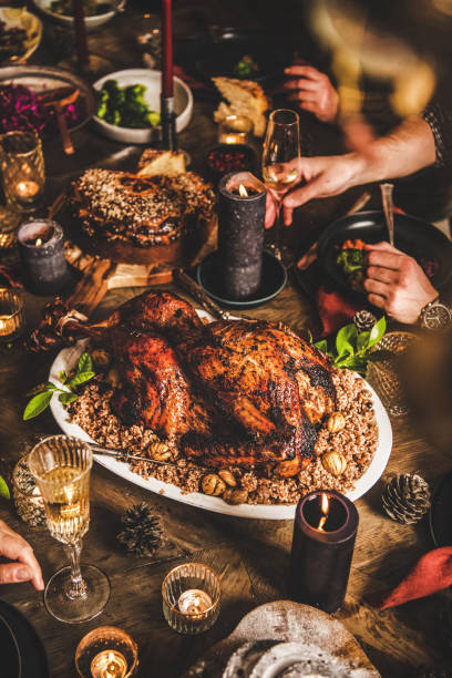 istock Friends celebrating Christmas over festive table with whole roasted Turkey 1284296565