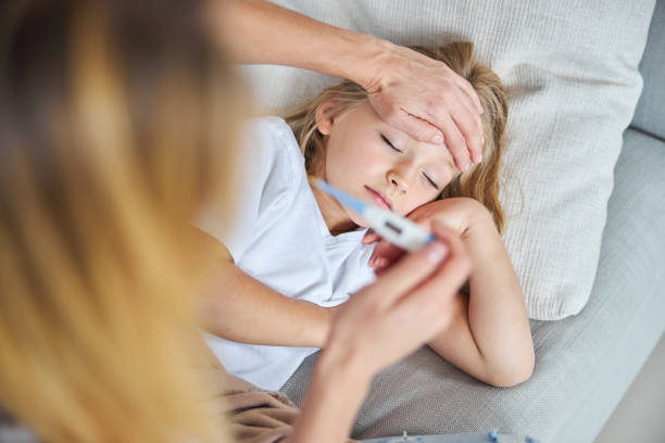 istock Cute small miss in white shirt resting and sleeping while feeling ill in home 1284297742