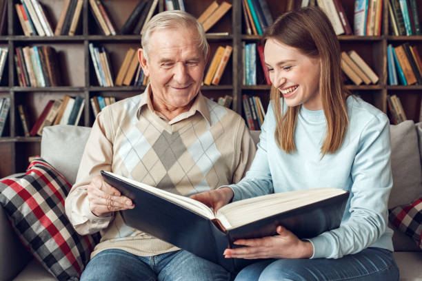 istock Father and daughter at home library sitting reading book cheerful 1284300512