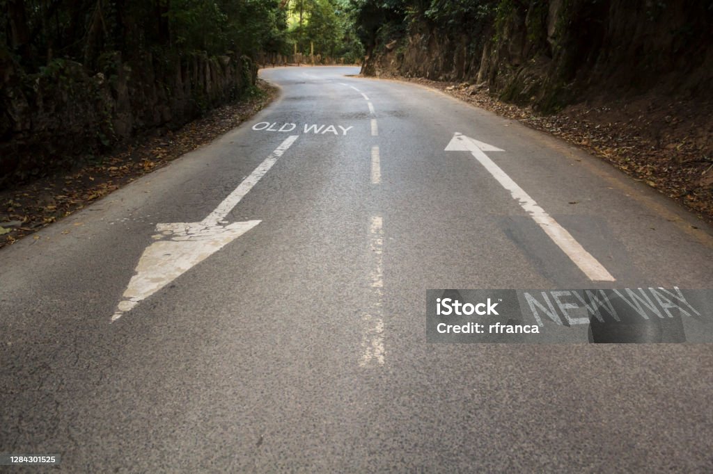 Road with the inscription Old way, New way with directional arrows. Concept for change, improvement and self-development Adaptation - Concept Stock Photo