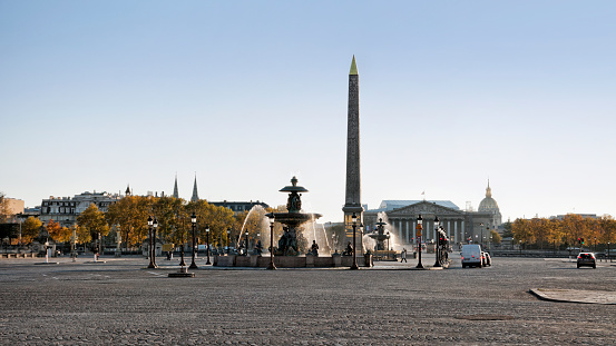 Usually crowded and bottled, the Concorde place is very uncrowded during second wave and second coronavirus lockdown in autumn, in Paris.  The Place de la Concorde is one of the largest place in Paris. It's aligned with Luxor Obelisk, Champs Elysées and Arc de Triomphe on one side, and Assemblée Nationale and Les Invalides on another side. There are less  cars because people must stay at home and be confine. Restaurants, stores, cinemas, museums... are closed. Paris, in France. November 5, 2020.