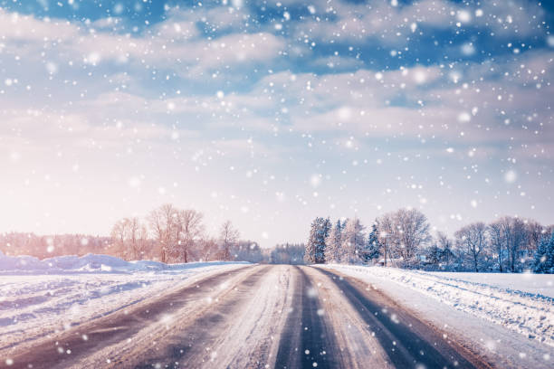 istock Winter road with snow with trees all around in snowfall 1284303265