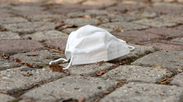 istock Protective Medical Mask Thrown On Road 1284303761
