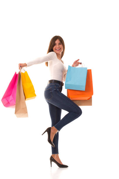 istock Brunette stands on white with purchases after sale 1284304435