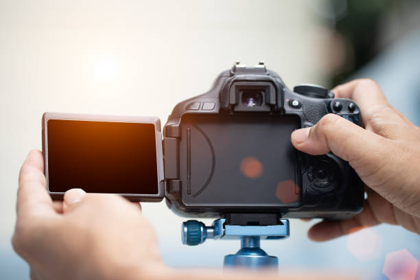istock The photographer hand is pressing the shutter with sun light fair 1284306148