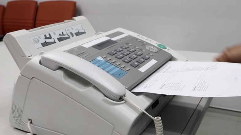 hand man are using a fax machine in the office, equipment for data transmission.