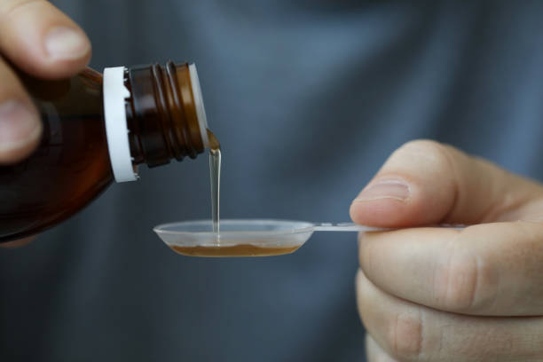 istock Guy measures desired dosage of medicine 1284308005