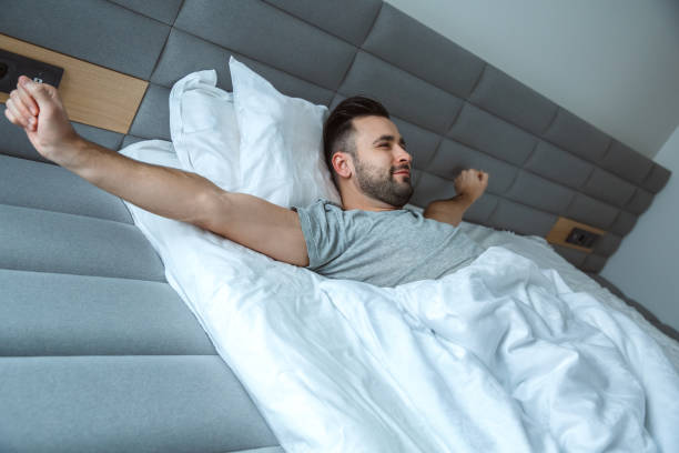 istock Bachelor man daily routine single lifestyle morning concept awakening stretching 1284308115