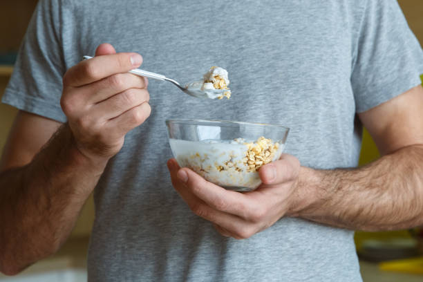 istock Bachelor man daily routine in a kitchen single lifestyle concept muesli with yoghurt close-up 1284308120