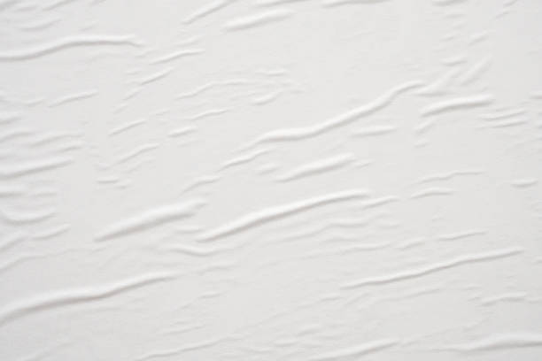 istock Blank white crumpled and creased paper poster texture background 1284308229