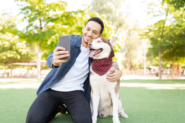 istock Latin dog owner taking a selfie with his big dog 1284308898