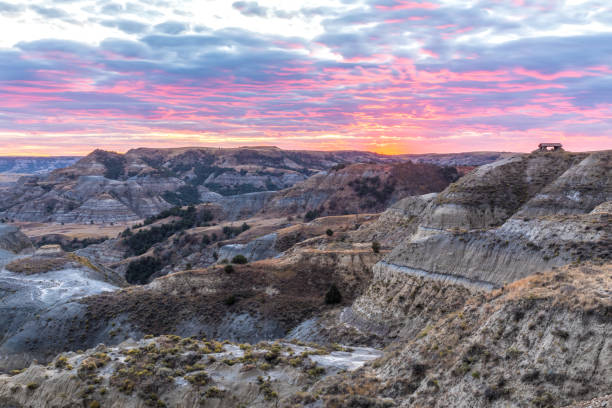 Majestic Sunset Scene in Theodore Roosevelt National Park Sunset view overlooking the rugged canyonlands of North Dakota's Theodore Roosevelt National Park near the popular River Bend Overlook. butte rocky outcrop photos stock pictures, royalty-free photos & images