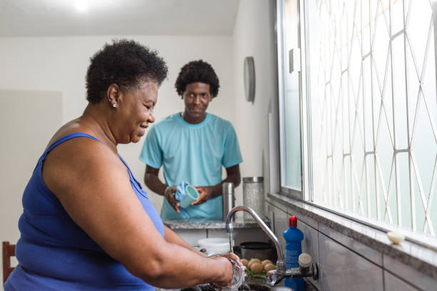 istock Mother and son washing dishes 1284312232