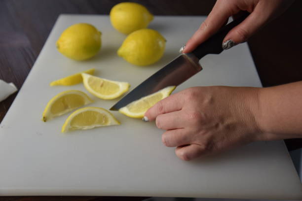 istock Hand chopping lemins with a knife 1284312944
