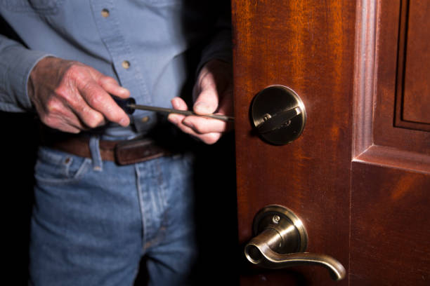 istock Worker or home owner installing or repairing new lock on doors. 1284314878