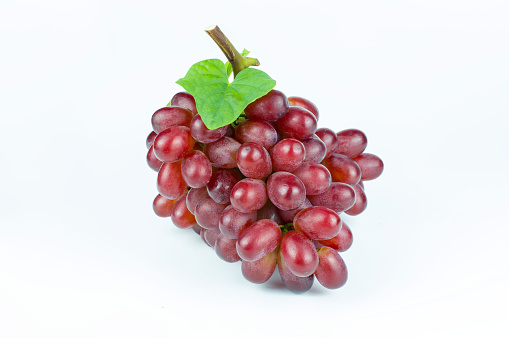 Ripe red grape. Pink bunch with leaves isolated on white. Vitis vinifera