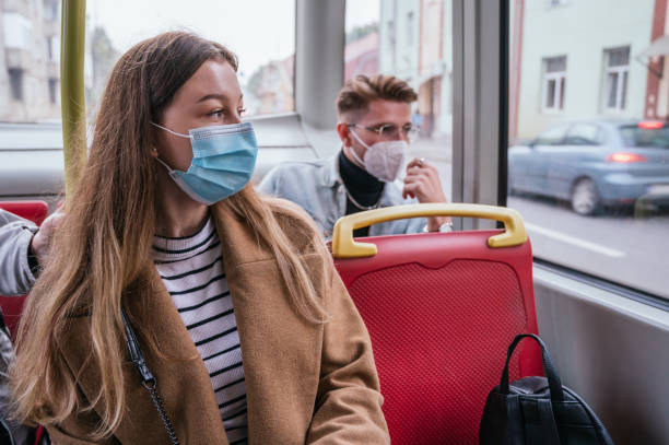 istock People wearing a mask and sitting in public transport 1284319402