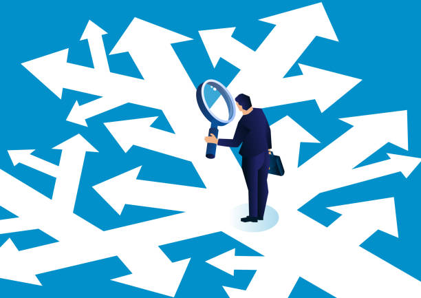 Businessman holding a magnifying glass standing in a complicated arrow path observing and making a choice