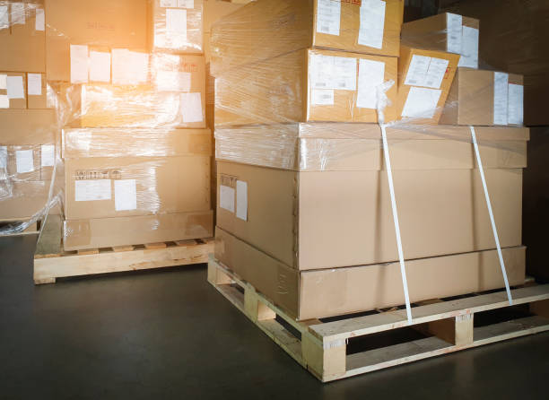 istock Cargo shipment boxes. Stack of cardboard boxes on pallet rack at the warehouse storage. Manufacturing and warehousing. 1284331564