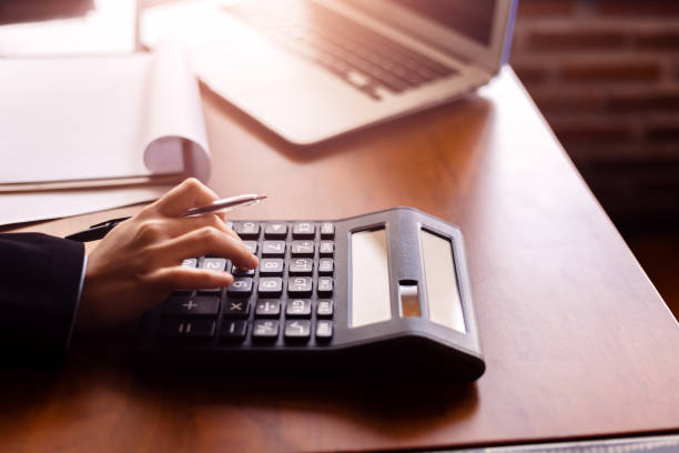 istock Business women  working with calculator and  business document on office table in office. finance accounting concept. 1284332443