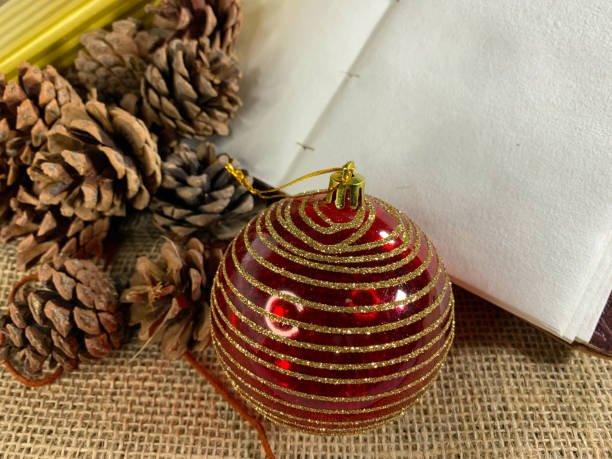 istock Notebook with pine cones and gifts on linen 1284336077