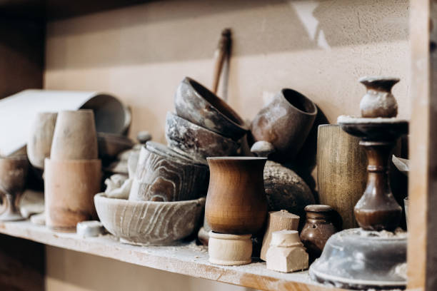 istock Handmade wooden tableware stands on a shelf in a workshop 1284338415