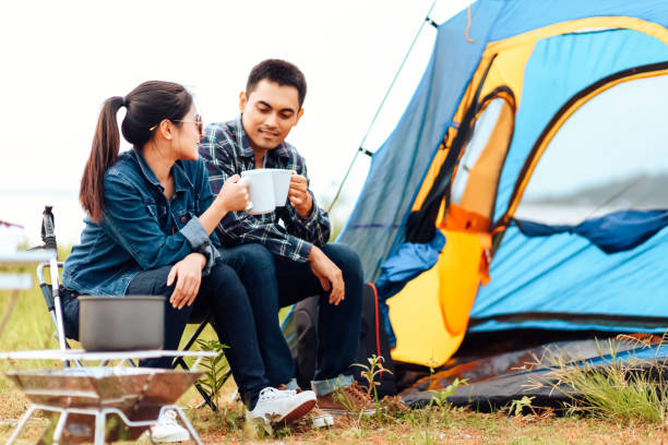 istock Couples drink coffee together during the morning camping. 1284339123