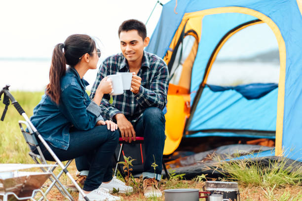 istock Couples drink coffee together during the morning camping. 1284339160