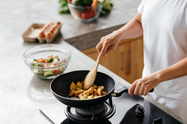 istock caucasian woman preparing chiken breasts 1284342551