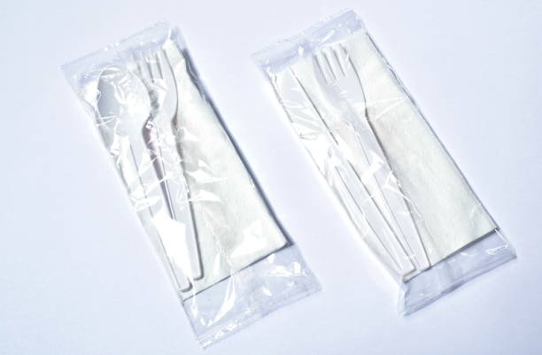 plastic spoon and fork with knife for single used in package on white background