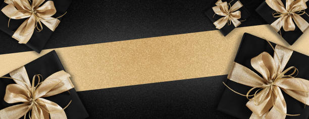 istock Black Friday gift package wrapped with golden ribbon bow  isolated on black background, template for promotional card with copy space 1284346503