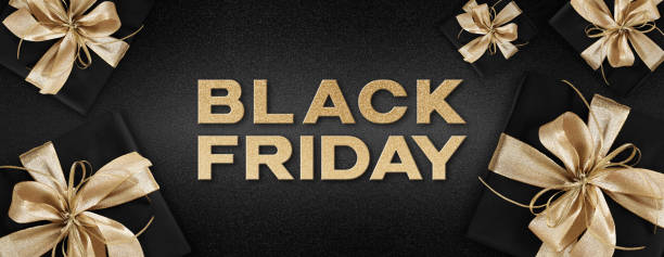 istock Black Friday text write with gift package wrapped with golden ribbon bow  isolated on black background, template for promotional card with copy space 1284346505