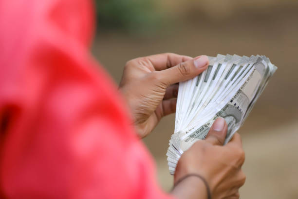 istock Young indian farmer counting money 1284346574