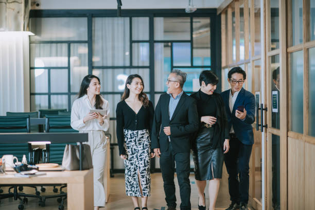 istock group of asian chinese successful office management team having discussion while walking toward camera 1284346652