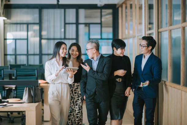 istock group of asian chinese successful office management team having discussion while walking toward camera 1284346688