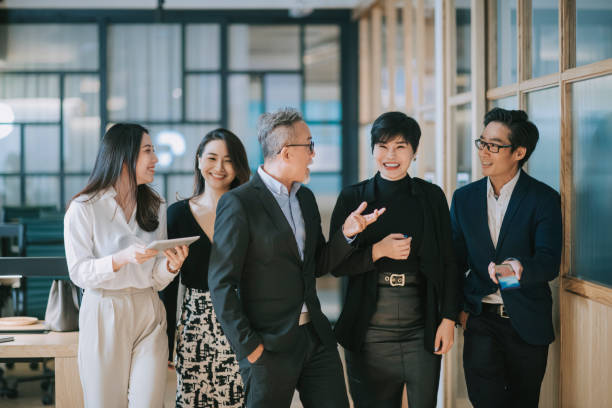 istock group of asian chinese successful office management team having discussion while walking toward camera 1284346689